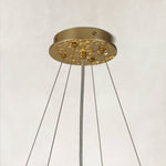 Gold-tone ceiling canopy and suspension cable detail.