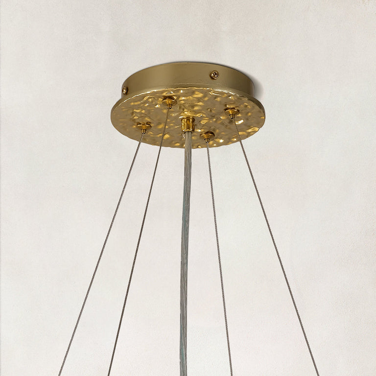 Gold-tone ceiling canopy and suspension cable detail.