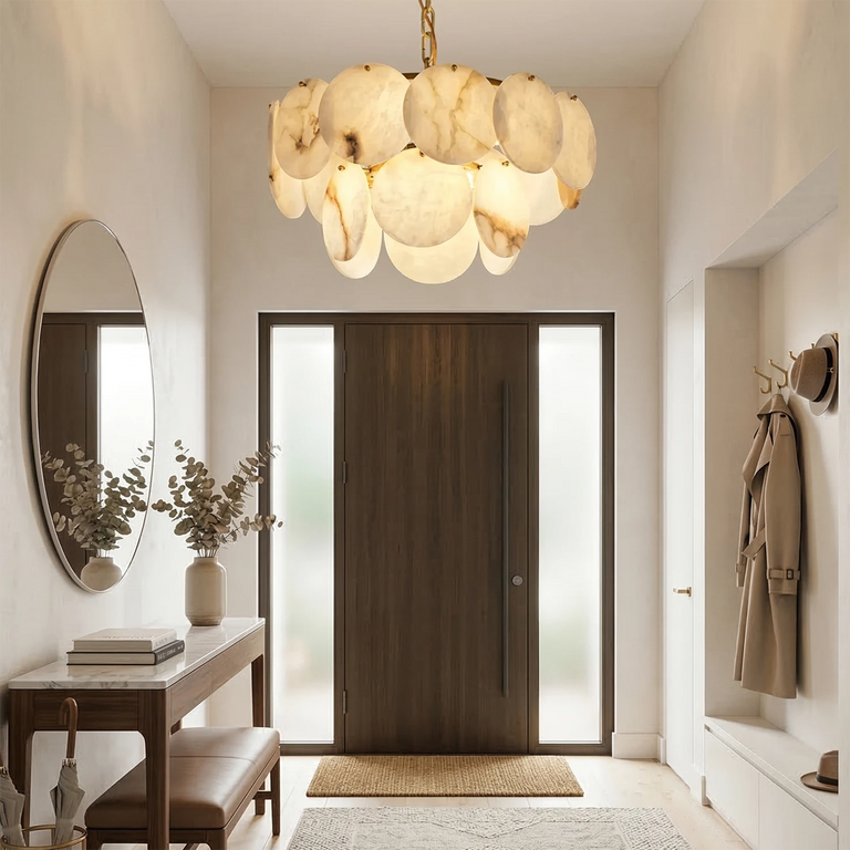 Two-tier alabaster disc chandelier illuminated above a furnished entryway