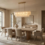Brass-finish two-tier alabaster panel chandelier above a dining table