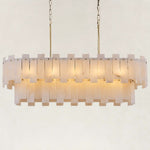 Illuminated brass-finish two-tier alabaster panel chandelier against a neutral background