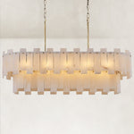Illuminated brass-finish two-tier alabaster panel chandelier against a neutral background