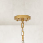Gold-tone chandelier ceiling canopy and chain.
