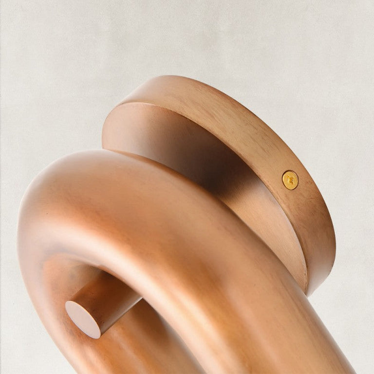 Bronze-tone wall-sconce backplate and U-shaped bend detail.