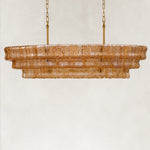 Unlit amber fluted-glass linear chandelier.