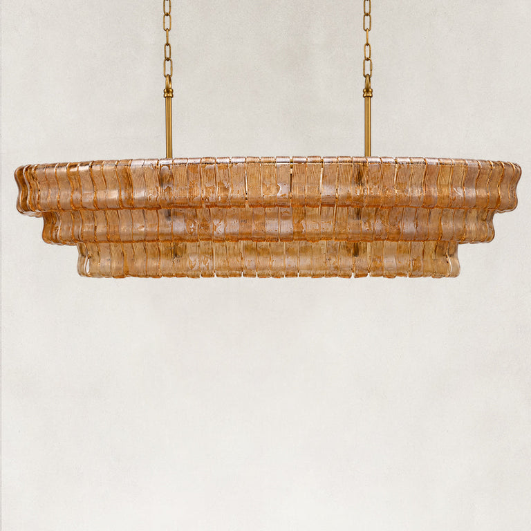 Unlit amber fluted-glass linear chandelier.
