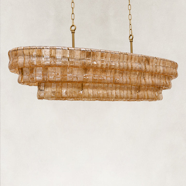 Unlit amber glass linear chandelier viewed at an angle.