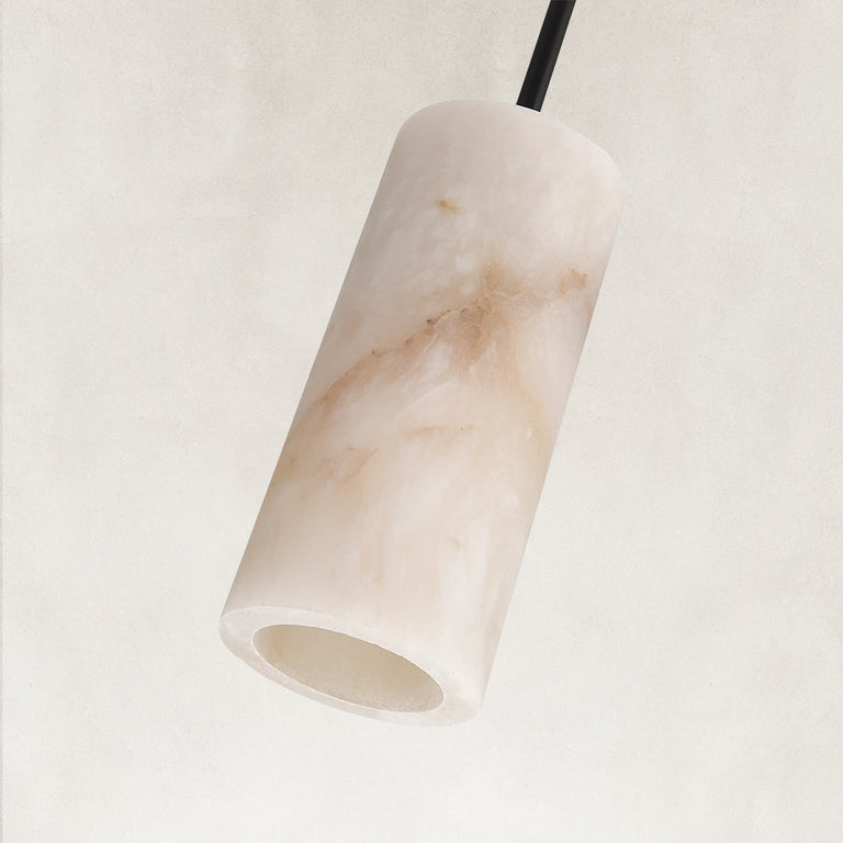 Unlit cylindrical stone pendant with a black rod.