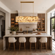 Variegated Scalloped Marble Island Pendant displayed in a furnished interior
