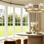 Gold ring chandelier beside full-height dining-room window
