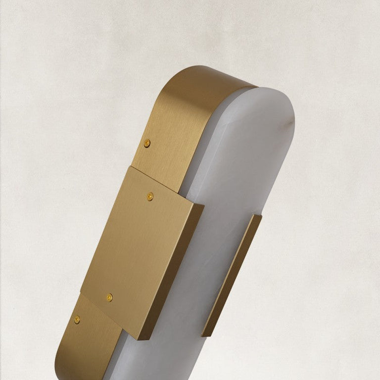 Rounded panel wall sconce, angled brass-tone side holder close view.
