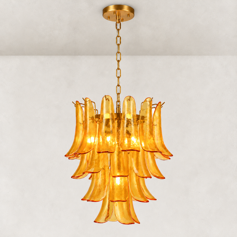 Illuminated tiered amber chandelier with curved panels and gold-tone chain suspension.