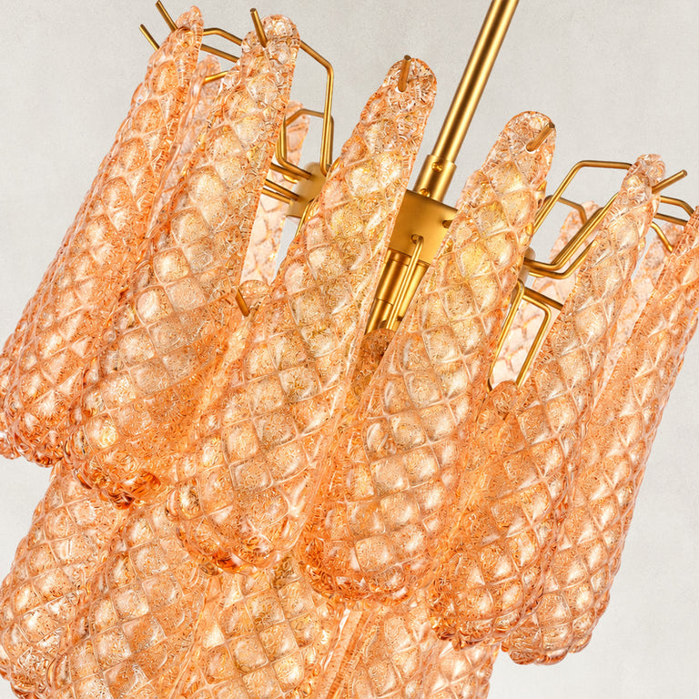 Close view of textured amber drops and gold-tone support arms.