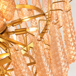 Close view of textured amber drops, gold-tone supports and illuminated bulbs.