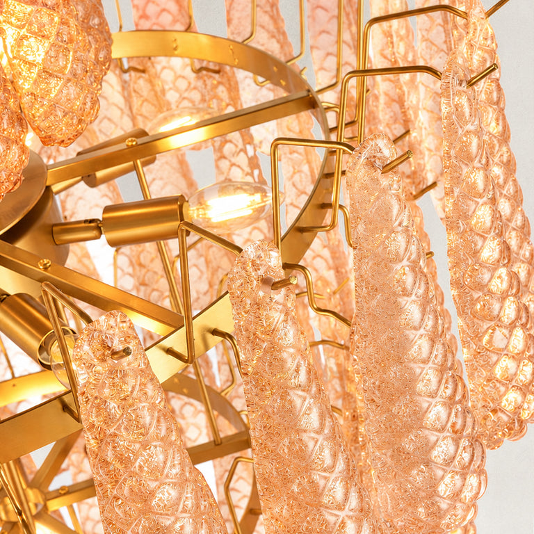 Close view of textured amber drops, gold-tone supports and illuminated bulbs.