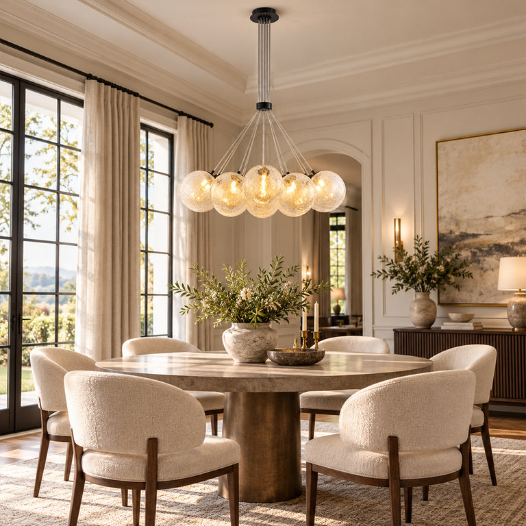 Glass globe chandelier with black hardware above a round dining table.