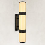 Black cylindrical wall sconce with a glowing white acrylic diffuser and rectangular backplate.