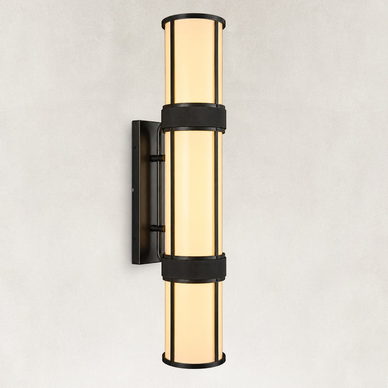 Black cylindrical wall sconce with a glowing white acrylic diffuser and rectangular backplate.