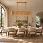 Linear ribbed wood chandelier above a rectangular dining table.