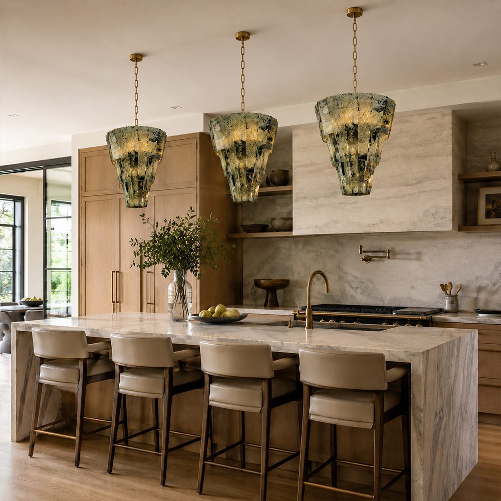 Three sculptural marble pendant lights above a contemporary kitchen island